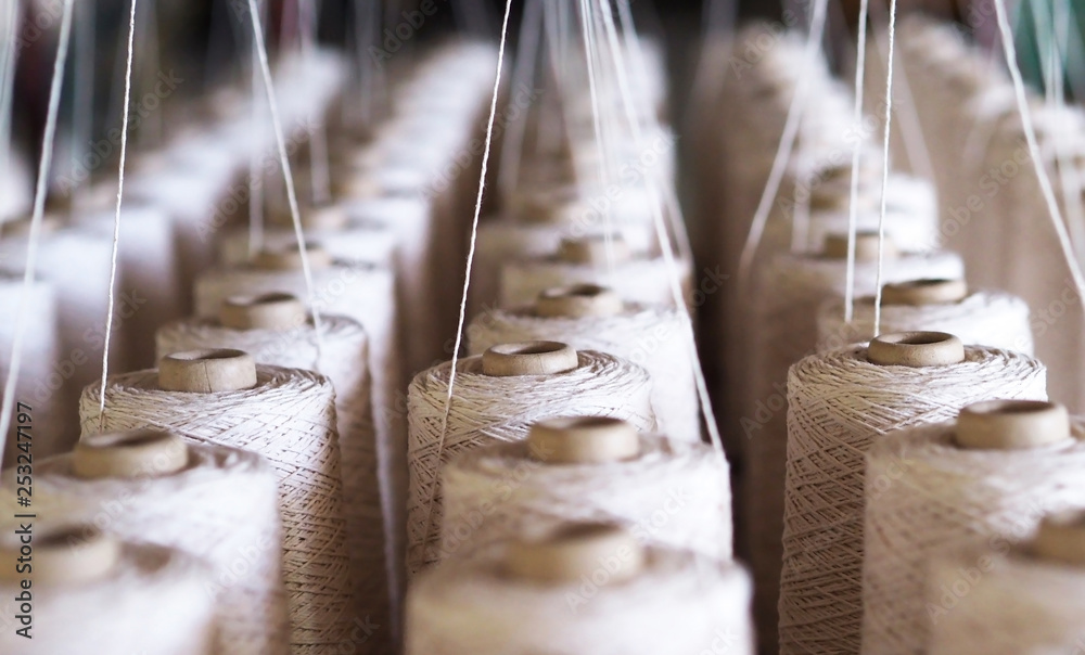 Row of textile threads industry . - obrazy, fototapety, plakaty 