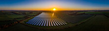 Aerial Looking Over A Modern Solar Farm At Sunrise In The English Countryside Panoramic