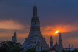 Fototapeta Paryż - Twilight wallpaper in the evening,the sun going back to the horizon,Wat Arun Ratchawaramaram is a temple along the ChaoPhraya River is an important place and a beautiful tourist destination in Bangkok