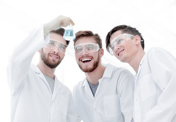 Wall Mural - happy scientists look at the result of their work