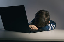 Closeup Picture Of Bullying Teen Boy Feeling Upset Infront Of Computer. Stressed Sad Boy Is Bullying By His Classmates