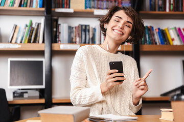 Sticker - Smiling young student girl studying