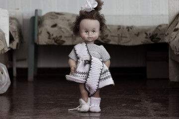 Wall Mural - The doll stands between the beds in the bedroom of the orphanage