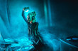 © LIGHTFIELD STUDIOS - happy dj woman with blonde hair listening music in headphones in nightclub with smoke