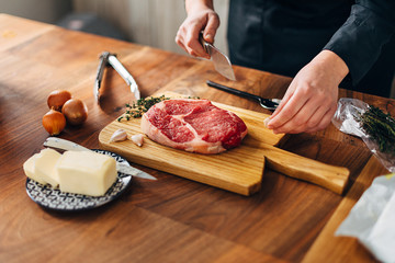 Overhead shot of chef preparing ribeye in a kitchen