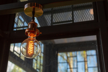 Wall Mural - Close up of Illuminated light bulb with copy space.