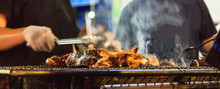 Traditional Thai Street Food, Beef barbecue grill on outdoor fireplace for roasting meat, cooked over open flame or live coal, basting with seasoned sauce. Thailand Food Travel and Gourmet concept