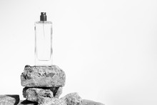 Luxury Perfume Bottle Glass Packaging With Stone Rock Concrete Grunge On White Background, Aroma Smell Of Cosmetic Beauty Container Clear