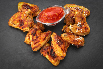 Wall Mural - Baked chicken wings with sesame and sauce. Food background. Top view