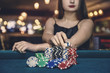 © RomanR - Female hand taking poker chips from pile