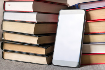 smartphone among books, many books, 2 stacks of books