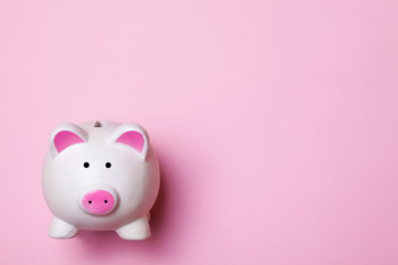 Poster - White piggy bank isolated on pink. Money saving background.