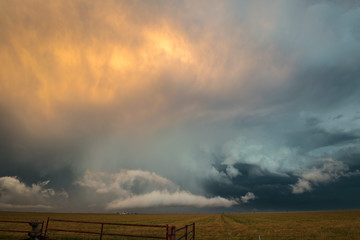 Wall Mural - beautiful orange and blue colors at the back of a texas severe thunderstorm. amazing colors at sunse