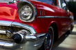 Front side head lights an bumper of a red colored 1957 Chevrolet