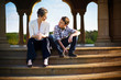 © Erickson Stock - Mother and son sitting on the steps of an opulent rotunda.