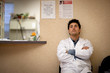 © Erickson Stock - Anxious doctor sitting and waiting in front of his office.