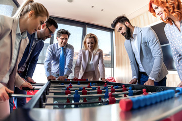 Poster - Coworkers playing table football