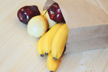 A Paper Bag With Purchases From The Store. Fresh Fruits On The Table.