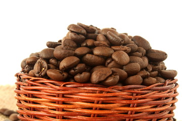 Wall Mural - dark roasted coffee beans closeup on white background