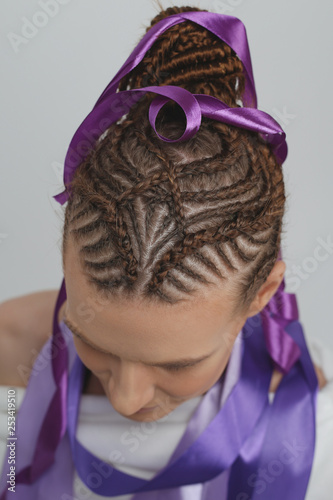 Girl On A White Background Hair Braided In A Tight