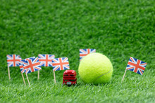 Tennis Ball With Union Jack Flag On Green Grass Background For Tennis In England Concept