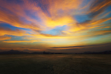 Wall Mural - empty concrete cement floor with dramatic evening orange and yellow sky .