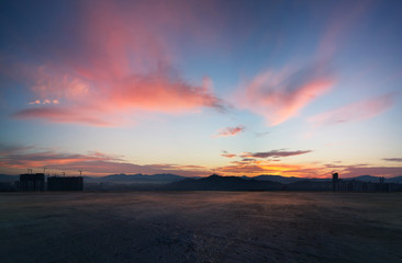 Wall Mural - empty concrete cement floor with dramatic sunrise purple and pink sky .