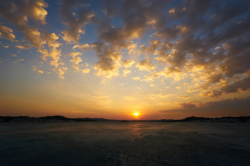 Wall Mural - empty concrete cement floor with beautiful and dramatic golden hour sunset sky .