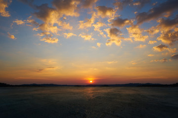 Wall Mural - empty concrete cement floor with beautiful and dramatic golden hour sunset sky .