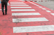 © chalongrat - People walking on a red crosswalk