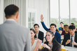 © Nawarit - Asian male speaker is speaking at seminars and workshops to the people in the meeting. Participants are raising their hands to ask questions.