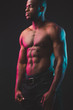 © alfa27 - Attractive African male fighter or boxer posing shirtless, isolated over dark background. Toned and ripped muscular fitness man under dramatic low key lighting, copy space.