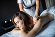 © NDABCREATIVITY - Health, beauty, resort and relaxation concept - beautiful woman in spa salon getting massage
