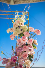 Wall Mural - Event decoration. Wedding chuppa at riverside decorated with fresh flowers. Florist workflow