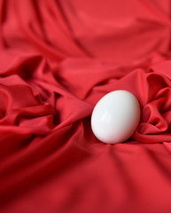 Poster - chicken boiled egg white on red fabric