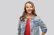 people concept - smiling teenage girl with long hair in denim jacket over grey background