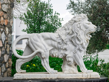 City Sculpture Of A White Lion With Open Mouth At The Entrance. Local Landmark