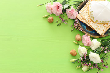 Pesah celebration concept (jewish Passover holiday) over green background. top view flat lay