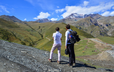 Happy couple hiking in mountains