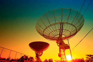 The silhouette of a radio telescope observatory