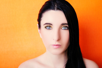 Young happy beautiful woman with bright make-up on bright background.