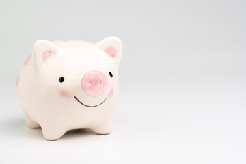  Smile pink piggy bank on white background with copy space using as happy saving and investment or positive economic and finance concept