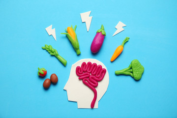 Plasticine figure of man and vegetarian food. Food for mind, charge of energy. Healthy lifestyle, detoxification and antioxidants.