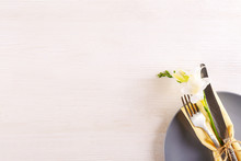 Table Setting Arrangement In Minimal Style With Easter Spring Holiday Attributes, Fork, Knife And Napkin. Background, Copy Space, Close Up, Flat Lay, Top View.