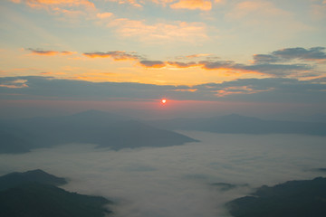 Morning sunrise over mountain and fog.