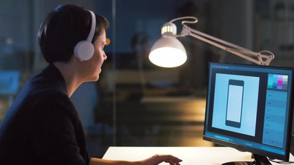 deadline and technology concept - graphic designer working with smartphone template on computer at dark night office