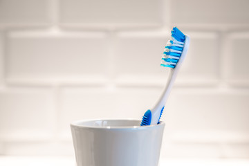      Toothbrush stands in a glass on a white background 