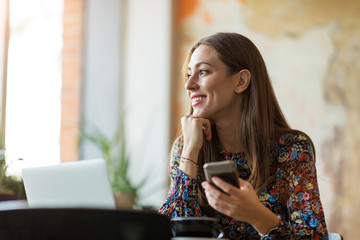 Wall Mural - young woman with laptop in cafe