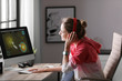 © New Africa - Young woman playing video game at home