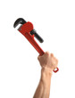 © New Africa - Man holding pipe wrench on white background. Construction tools